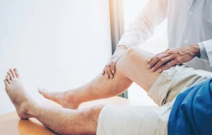 Doctor consulting patient with knee pain